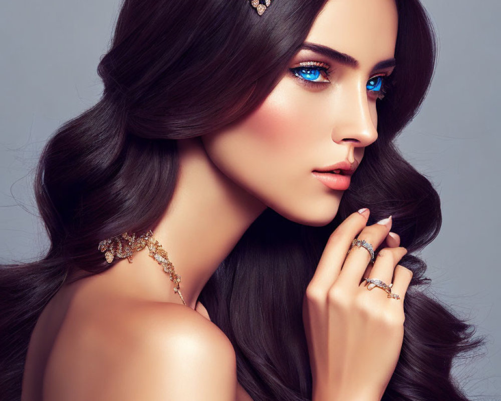 Woman with Long Dark Hair and Gold Jewelry in Sparkling Blue Eye Makeup