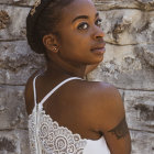 Woman in Braided Hair and Striking Makeup Poses in White Lace Dress