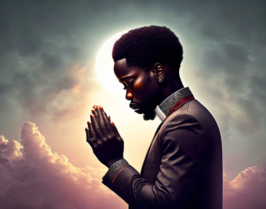 Man with Afro in Side Profile Praying Against Sky Background