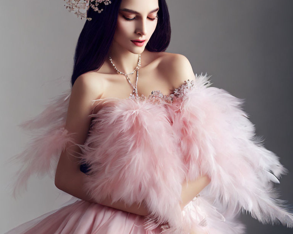 Elegant woman in pink tulle dress with feather details