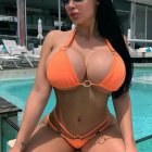 Woman in Orange Striped Bikini by Pool with Dark Hair