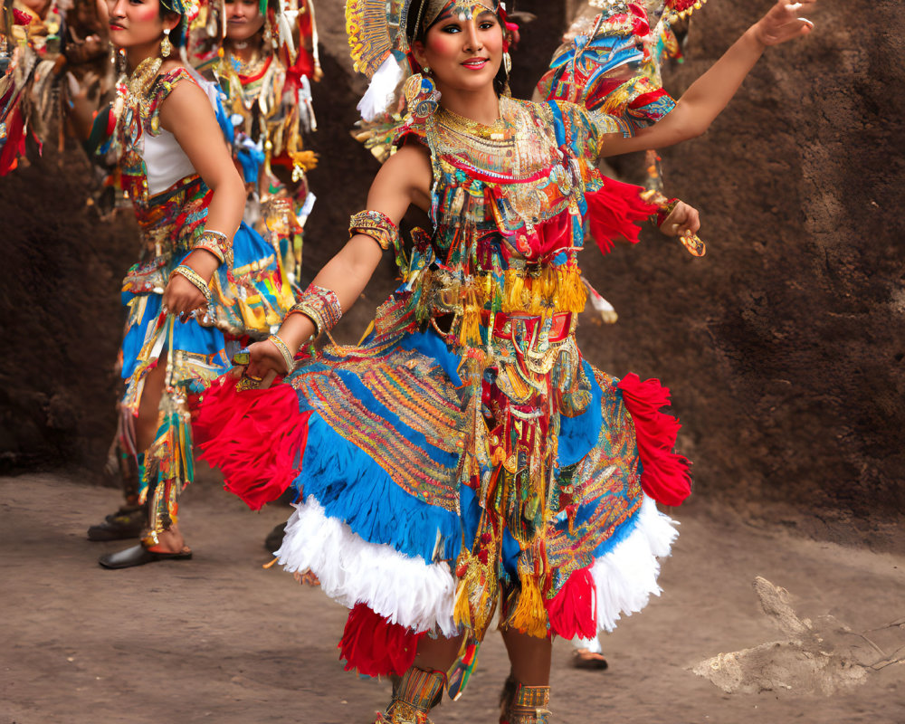 Vibrant traditional dancers in colorful costumes with feathered headdresses performing outdoors