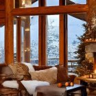Luxurious living room with wooden walls, plush sofas, fireplace, candles, and snowy tree view.