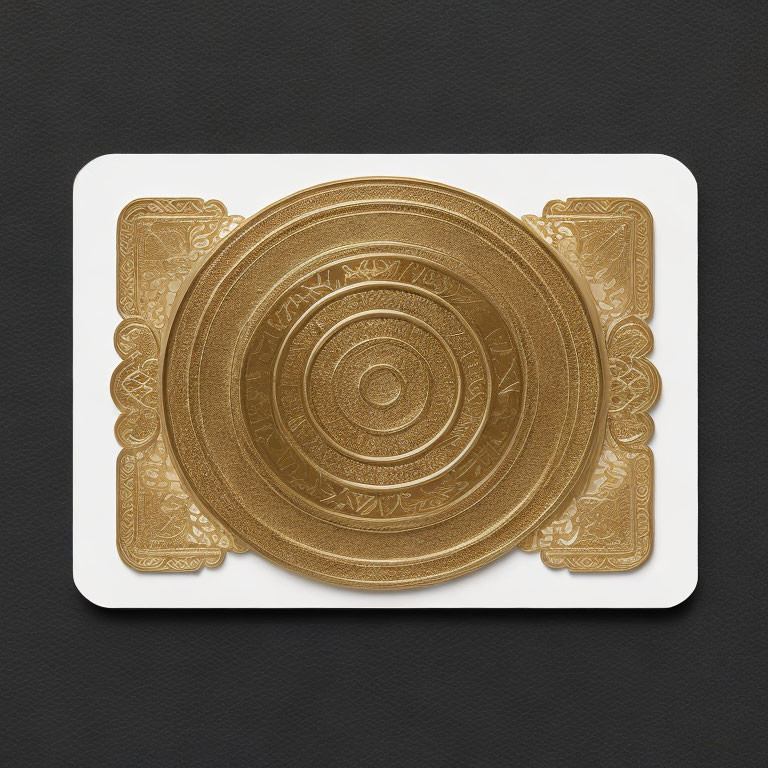 Intricate Golden Medallion on White Card Against Black Background