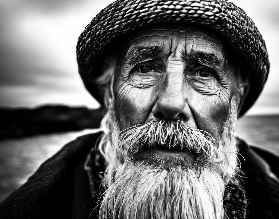 Elderly man with weathered face and fisherman's hat in natural setting