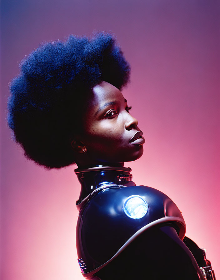 Portrait of Woman with Afro in Futuristic Outfit on Pink Background