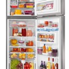 Assorted fresh foods neatly organized in filled refrigerator