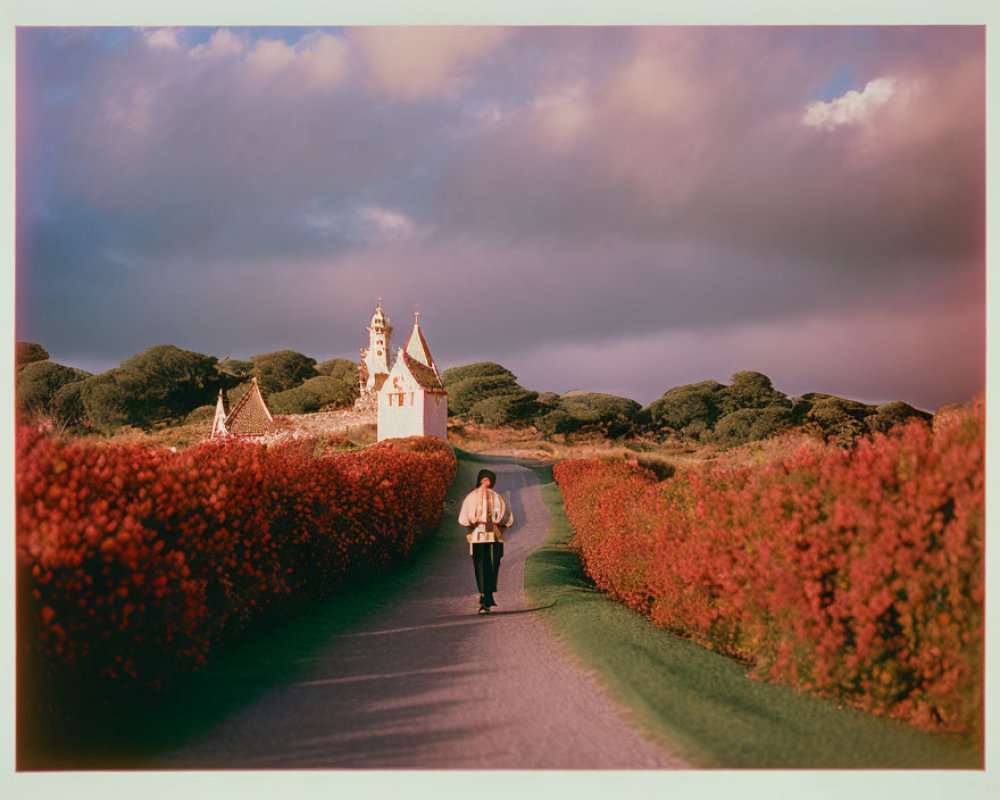 Solitary figure walking on picturesque road towards quaint church
