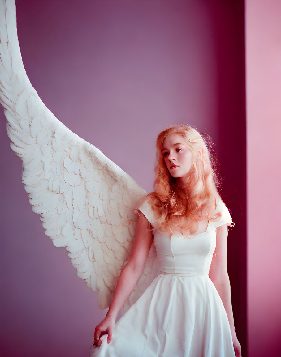 Blonde woman in white dress with angel wings on purple background