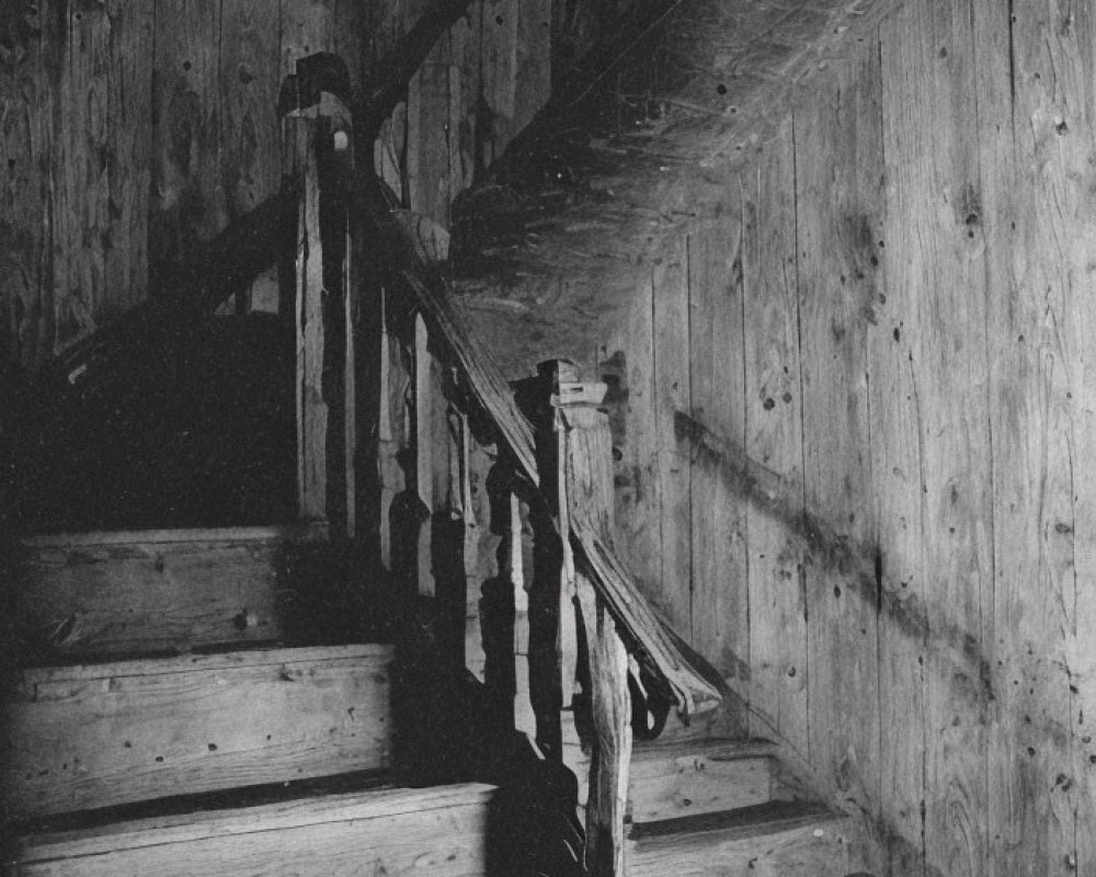Weathered wooden staircase with balusters in dimly lit setting