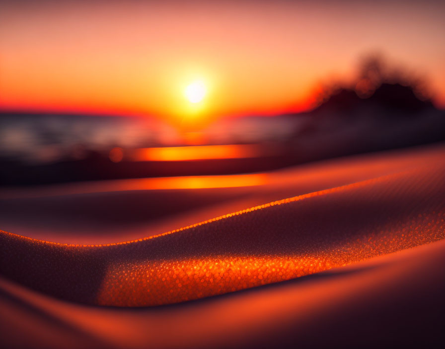 Rippled sand close-up with warm sunset glow