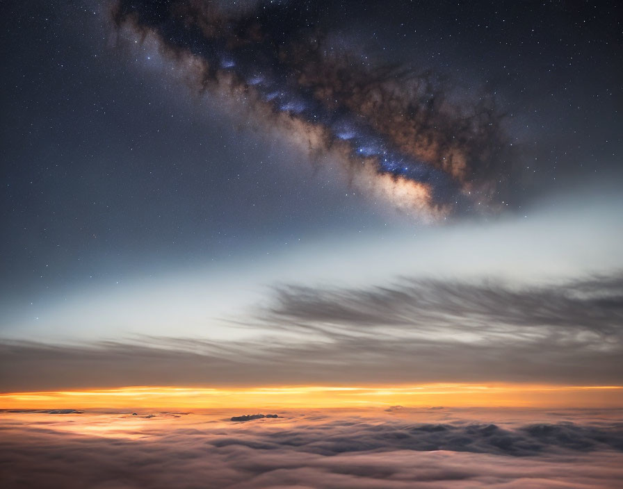 Starry sky with Milky Way above clouds at sunrise/sunset