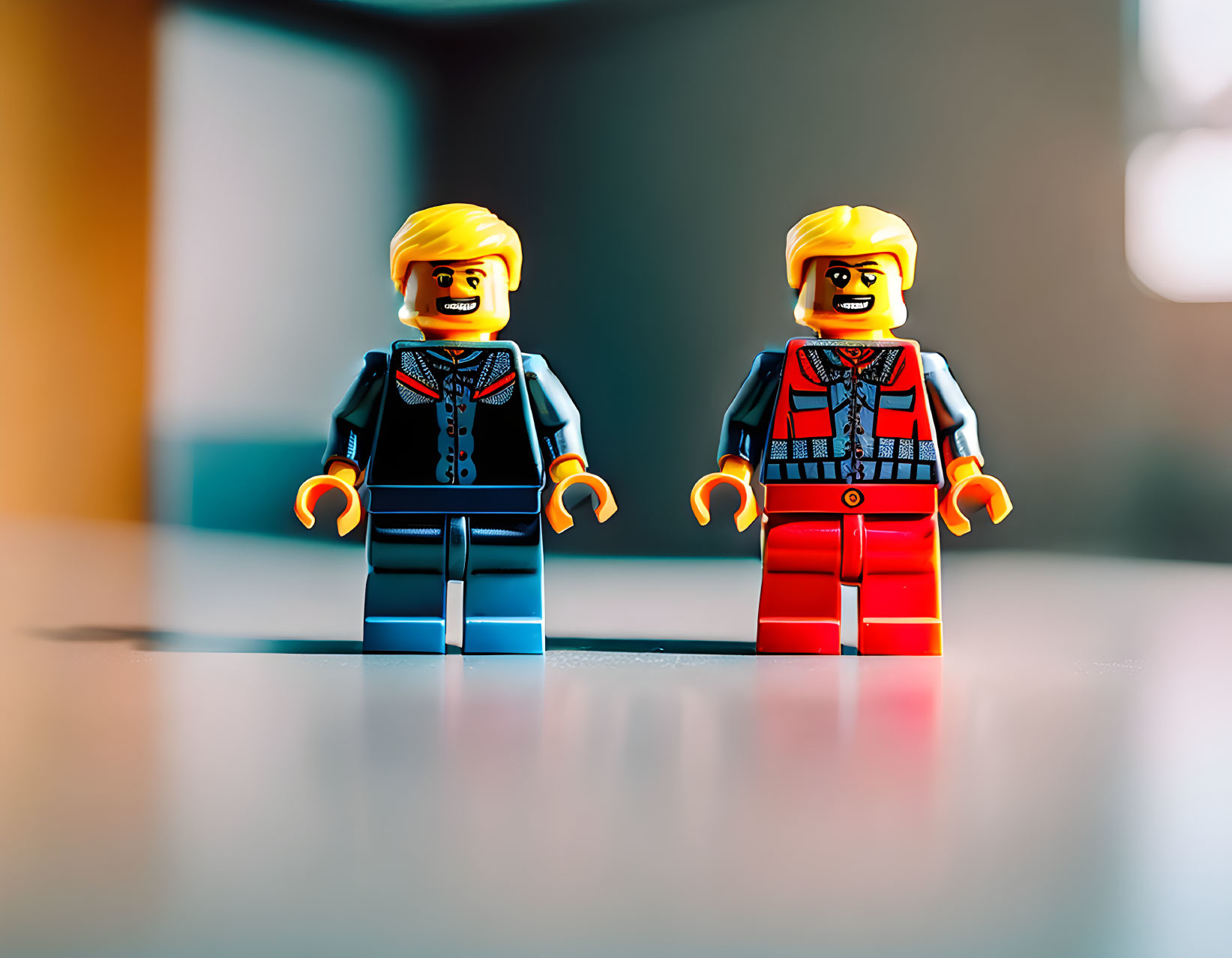 Two LEGO minifigures with beards in blue and red pants against blurred background