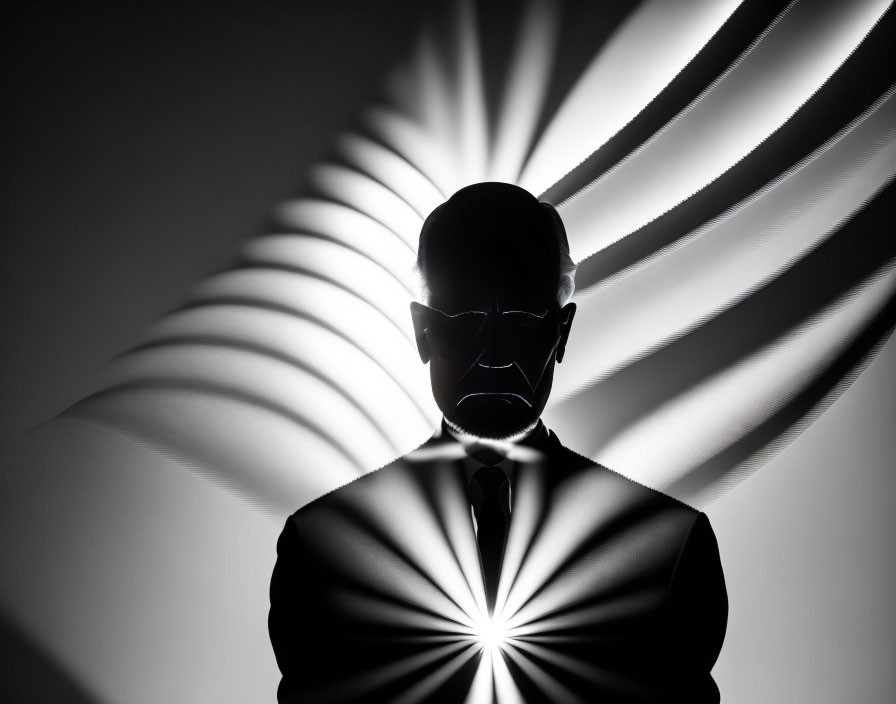 Person silhouette with glasses and radial light beams background.