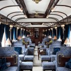 Vintage train carriage with ornate decor and affluent passengers dining and reflecting.