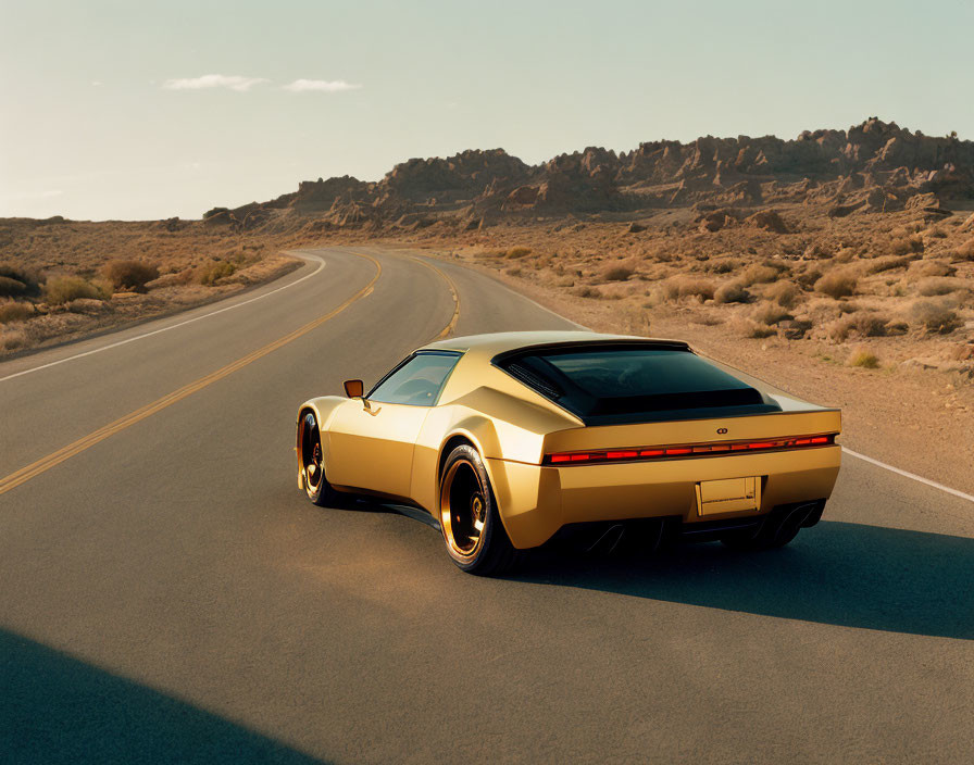 Golden retro-futuristic sports car on desert road with rocky terrain and clear blue sky