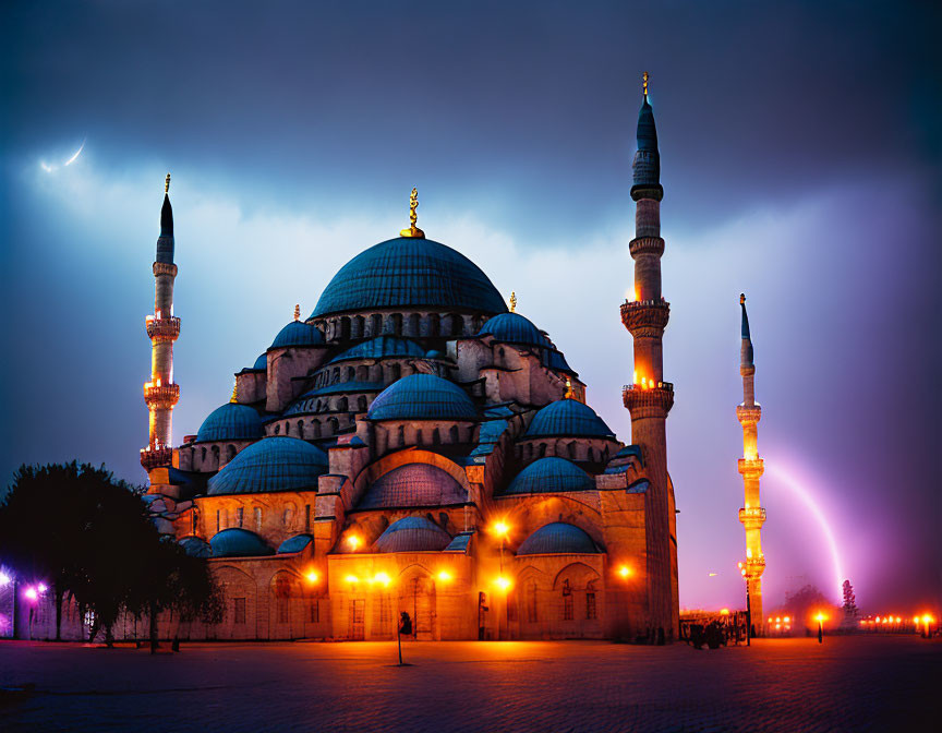 Majestic illuminated mosque with crescent moon in dramatic night sky