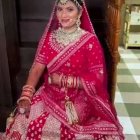 Traditional Indian Bridal Attire with Pink Saree and Gold Jewelry