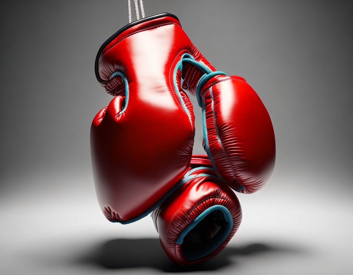 Red Boxing Gloves with White Stitching on Gray Background