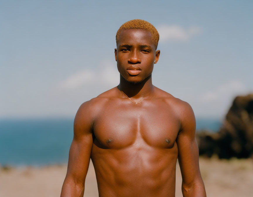 Blonde man on beach with neutral expression