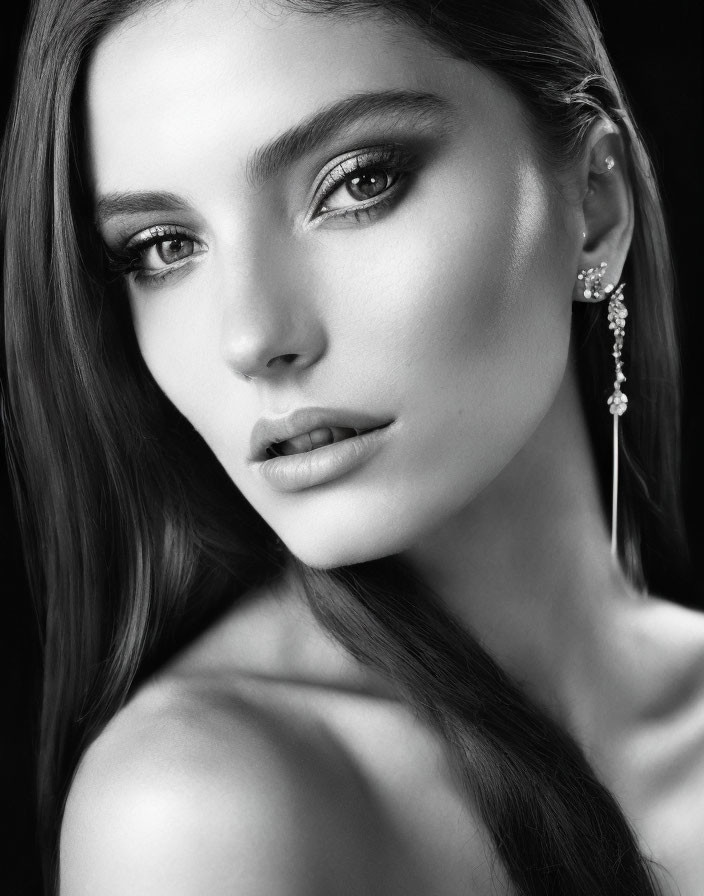 Monochrome portrait of woman with striking eyes and elegant earring