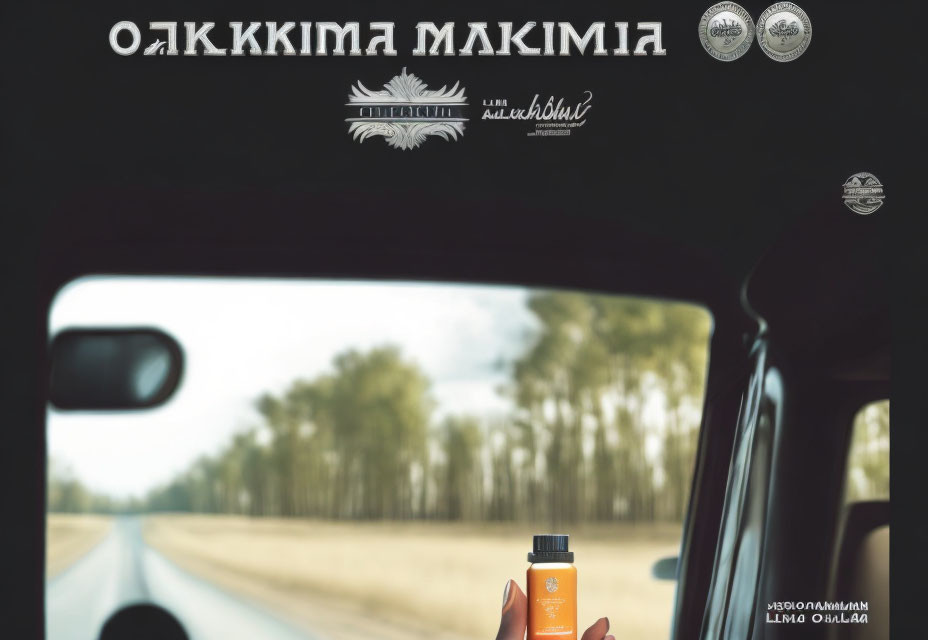 Hand holding small bottle with countryside view through car window and mirrored text.