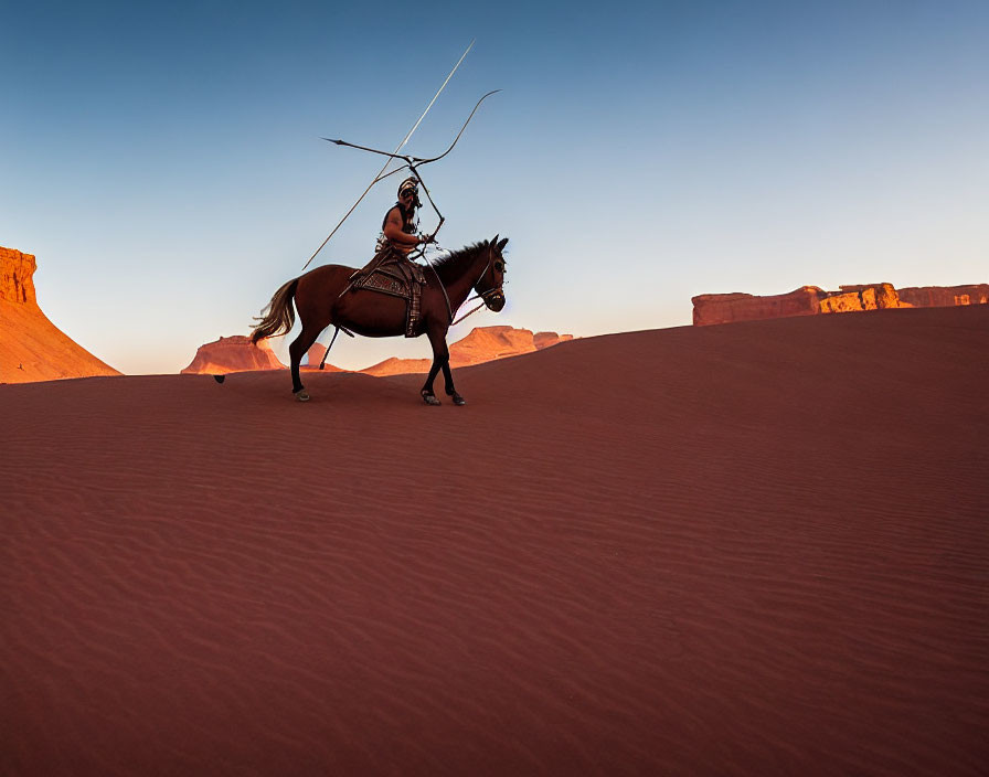 Horse and rider in desert landscape with dunes and rock formations