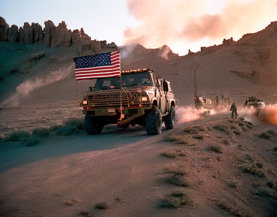 Military convoy with American flag in dusty desert at dusk