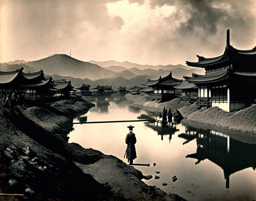 Vintage Black and White Photo of Person by Asian-style Buildings and Mountains