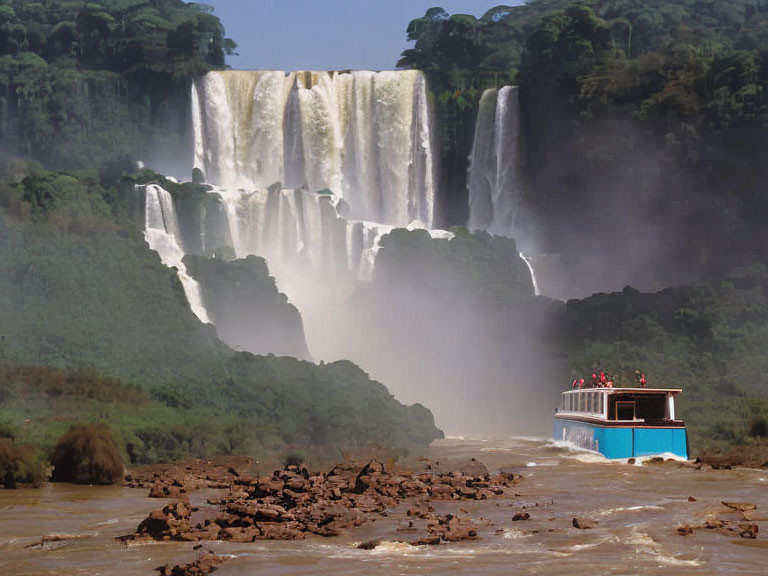 iguazu falls below a tourist boat touring 