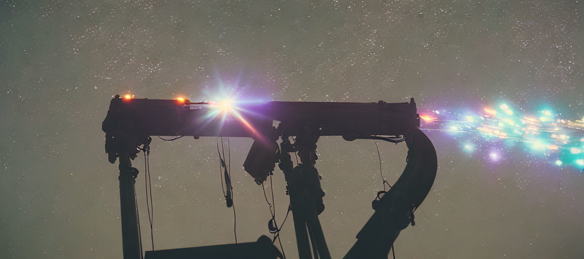 Telescope silhouette against starry sky with lens flare