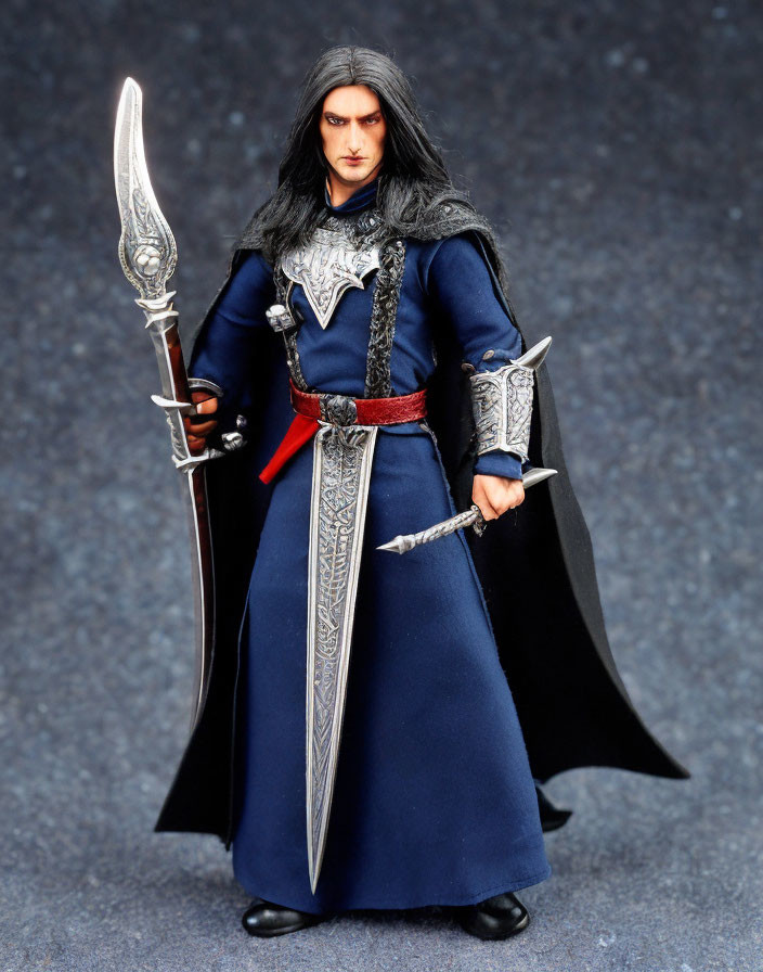 Fantasy character figurine with long black hair, blue tunic, silver armor, sword, and