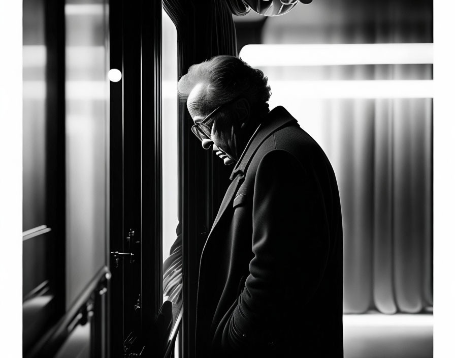 Silhouetted elderly man in profile with thoughtful expression