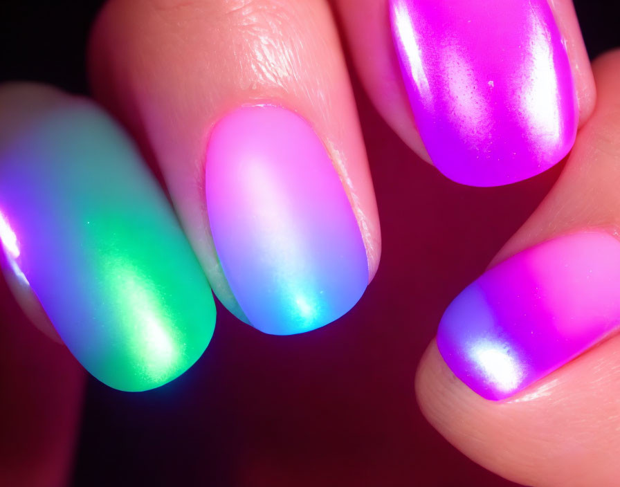 Vibrant neon gradient manicure with green, blue, and pink ombre effect