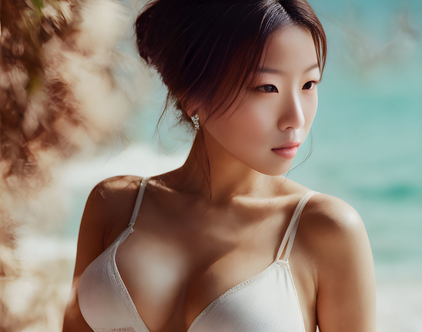 Woman in White Swimsuit Posing on Beach with Ocean Background