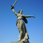 Warrior statue with horn under clear blue sky