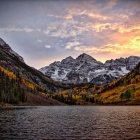 Colorful Sunset Scene Over Serene Lake and Majestic Mountains
