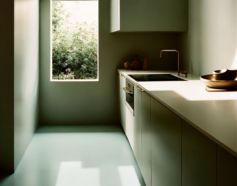 Minimalist Green-themed Kitchen with Sunlit Window and Clean Countertops