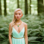 Woman in tiara and green dress standing in forest