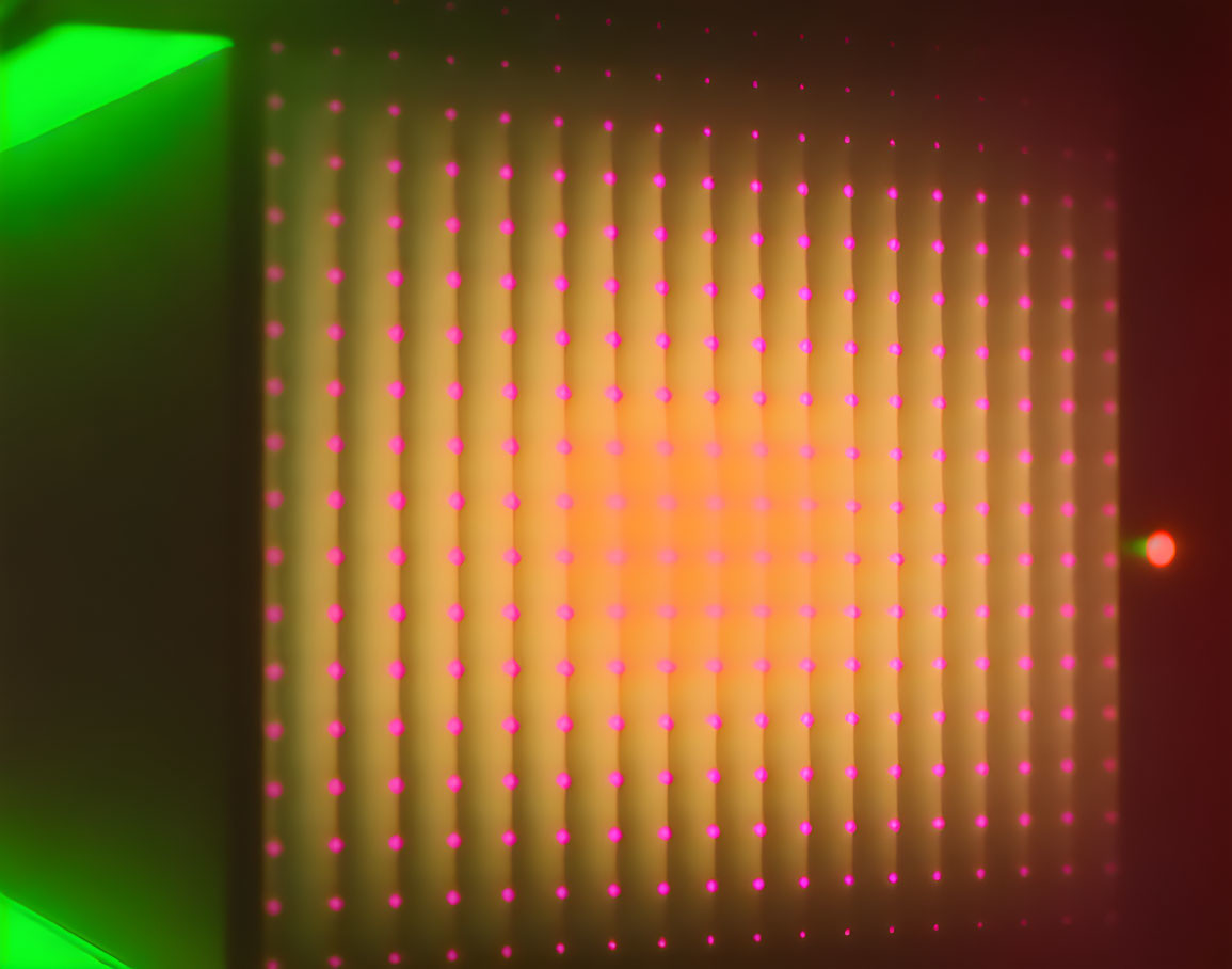 Grid of Red Dots with Green Light Source Creating Hazy Glow