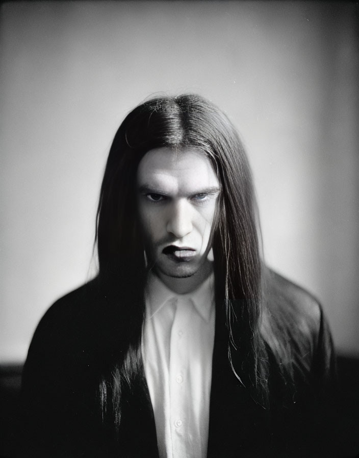 Monochrome portrait of a person with long straight hair and dark lipstick