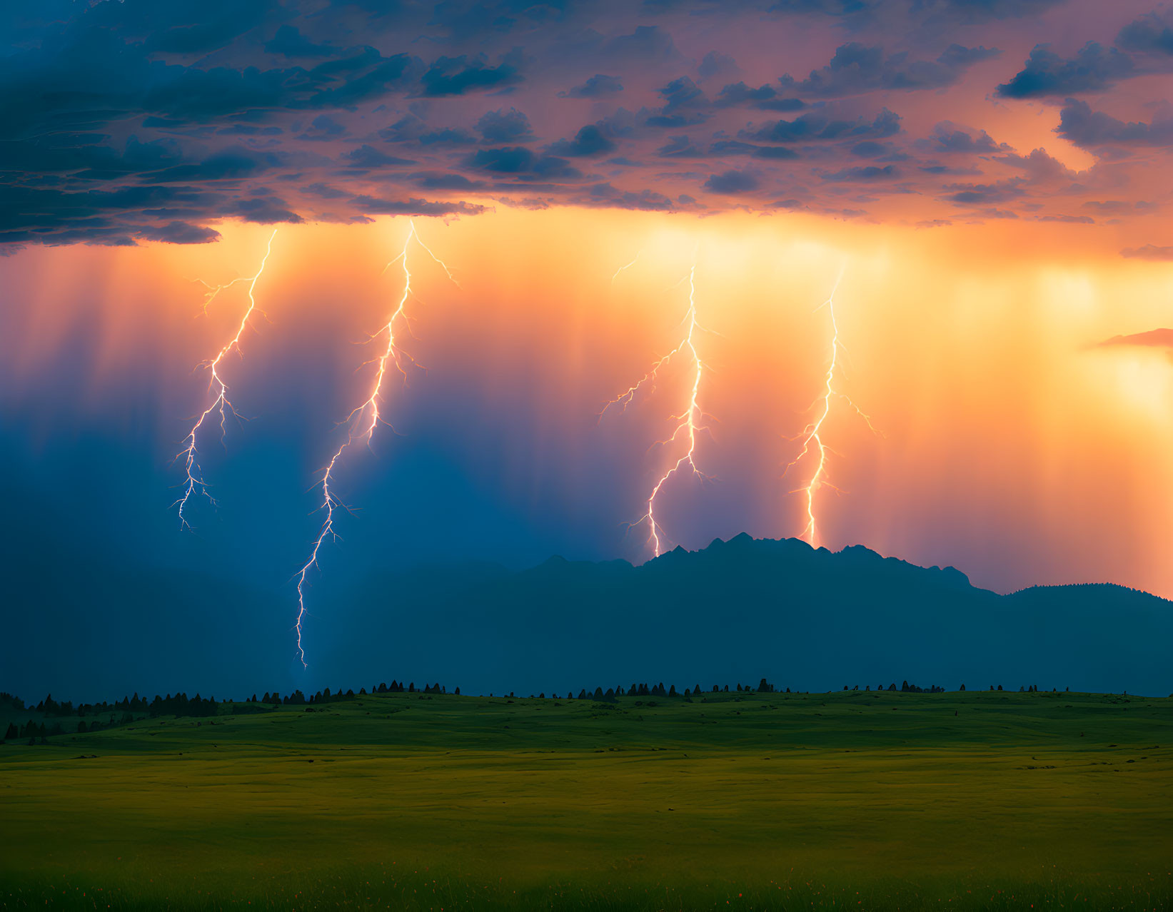 Dramatic landscape with lightning strikes above mountains and green field