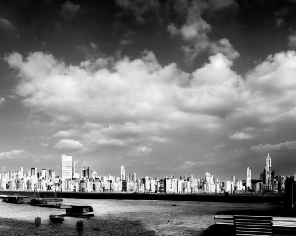 Monochrome city skyline with clouds and boats in foreground