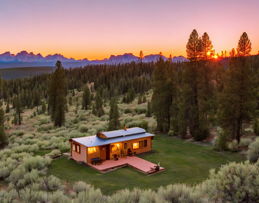 Secluded cabin in wilderness at dusk under orange sunset