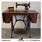 Steampunk-inspired sewing machine with brass details and gears on textured background