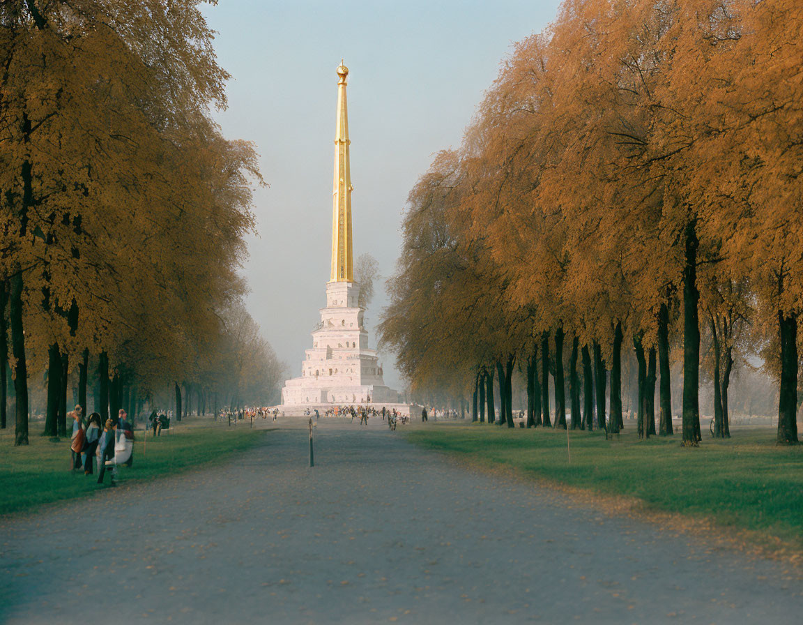 Tranquil Park Pathway with Golden Trees and Monument Spire