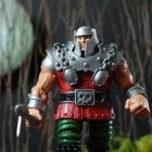 Fantasy warrior action figure in ornate armor with small axe on realistic backdrop