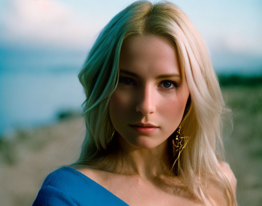 Blonde Woman Portrait in Blue Top with Earring and Aquatic Background