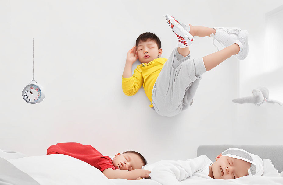 Children sleeping on bed with floating child in surreal room with gravity-defying clock and toy