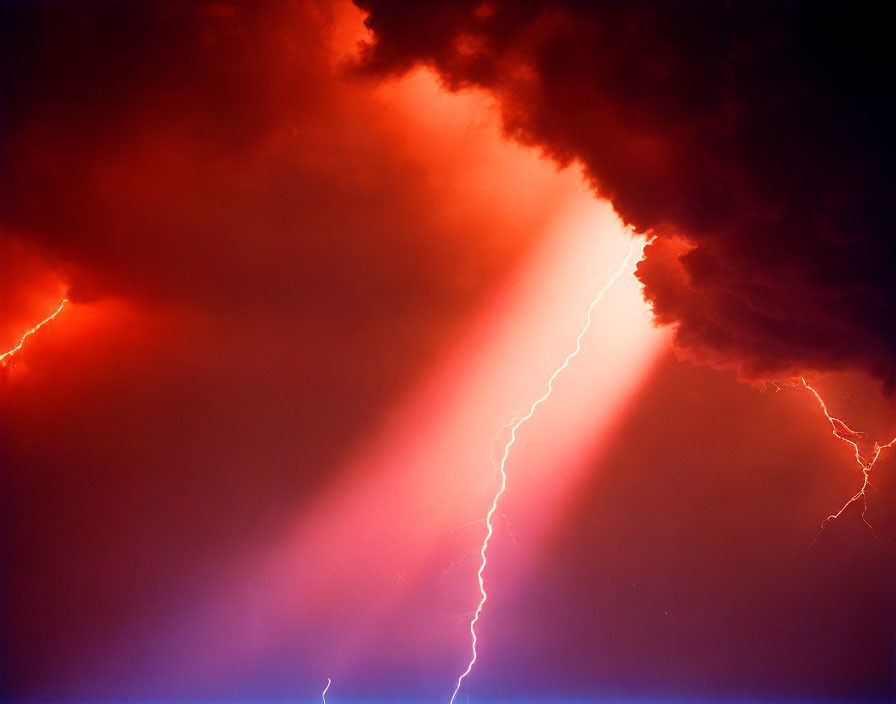 Dramatic lightning strike in dark storm clouds with orange and blue hues